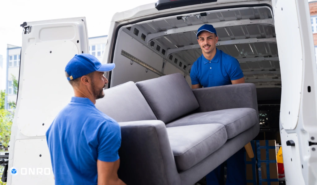 This image shows two man delivering furniture to the customer's door.